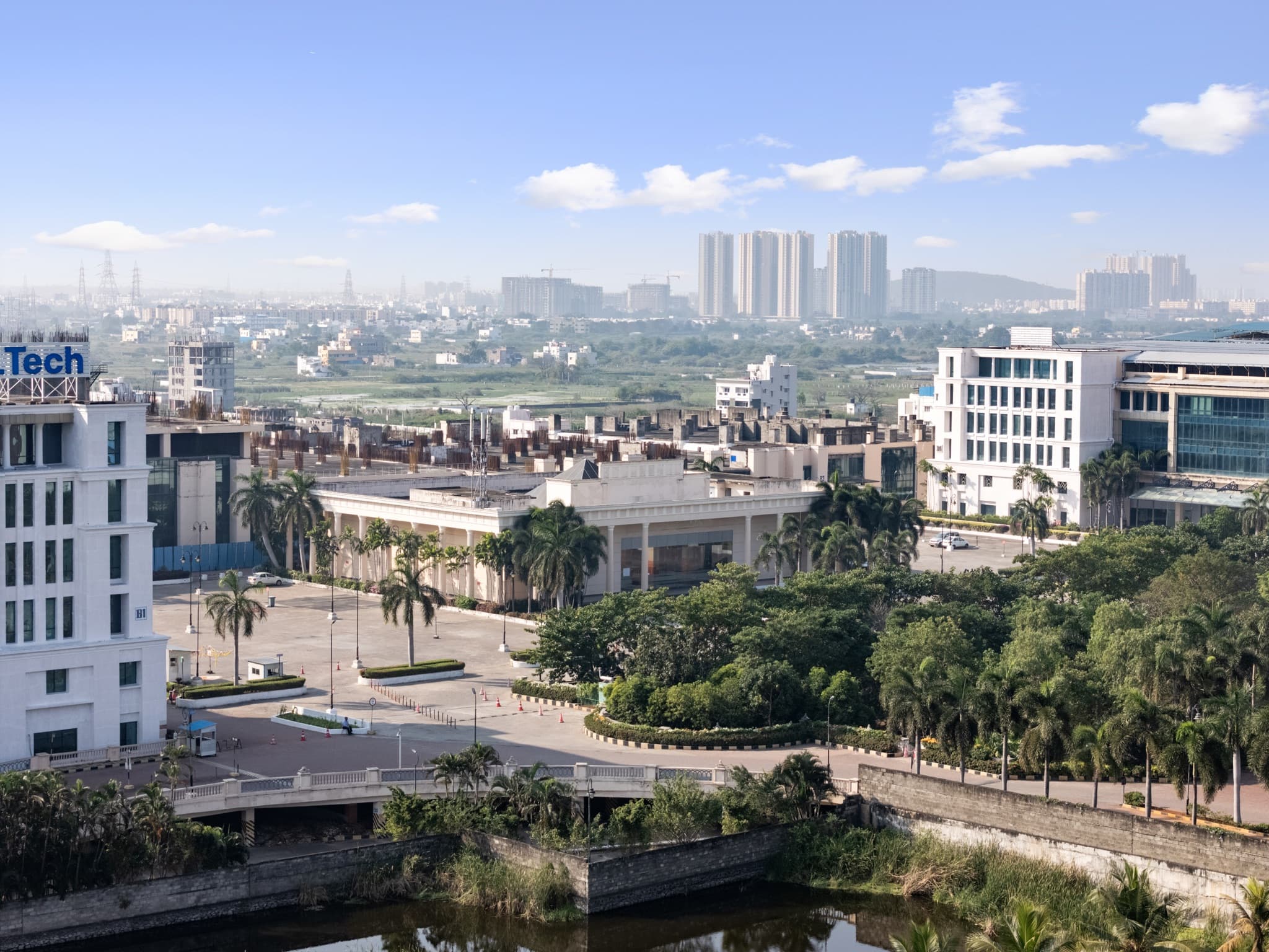 Campus aerial — multi-block layout with city backdrop