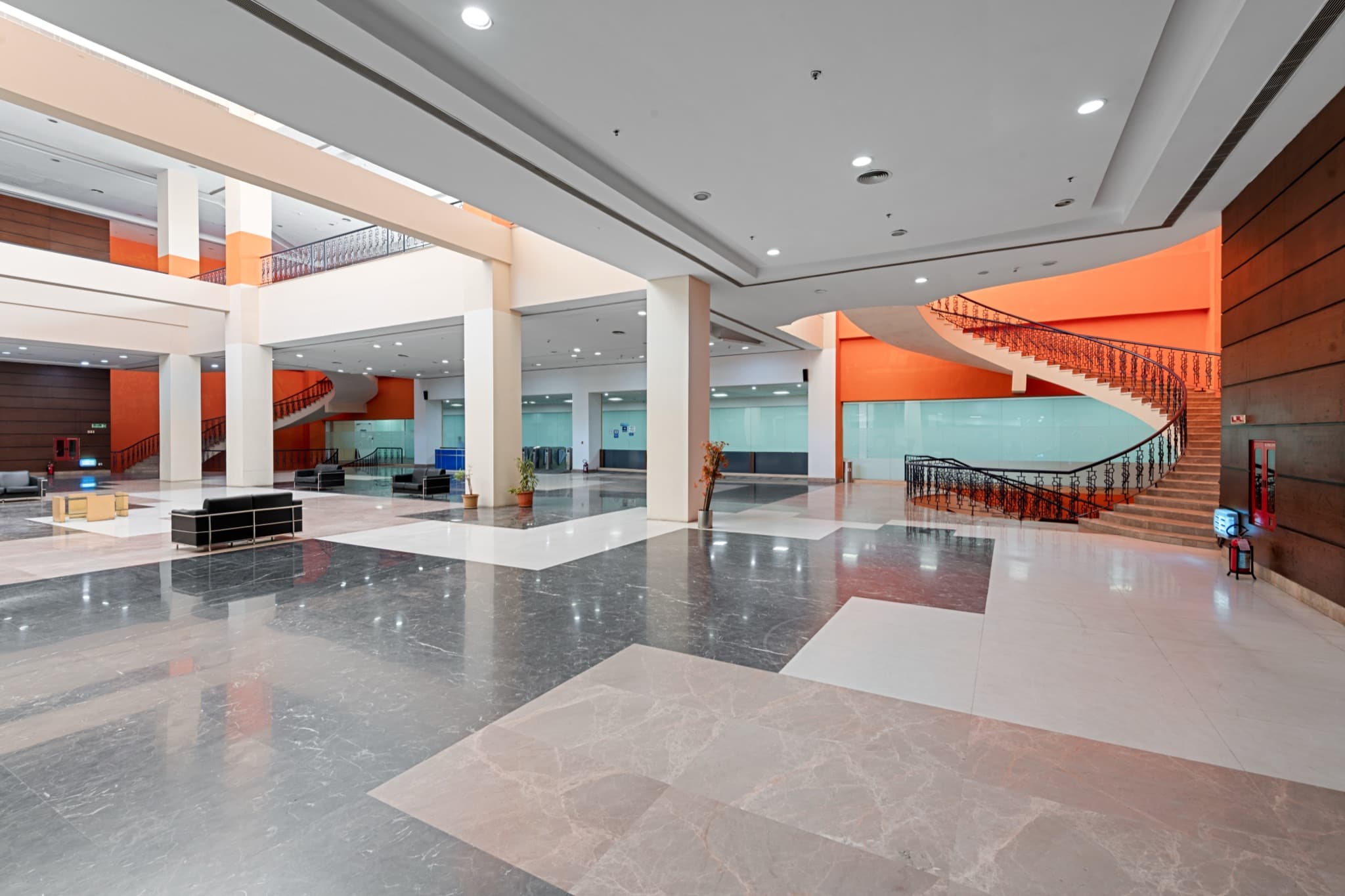 Block 2 lobby — sweeping staircase with orange accent walls